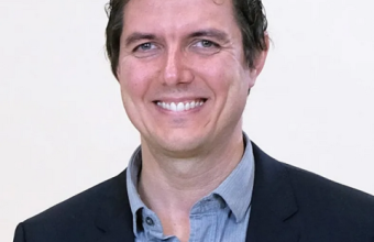 headshot of piccinini smiling